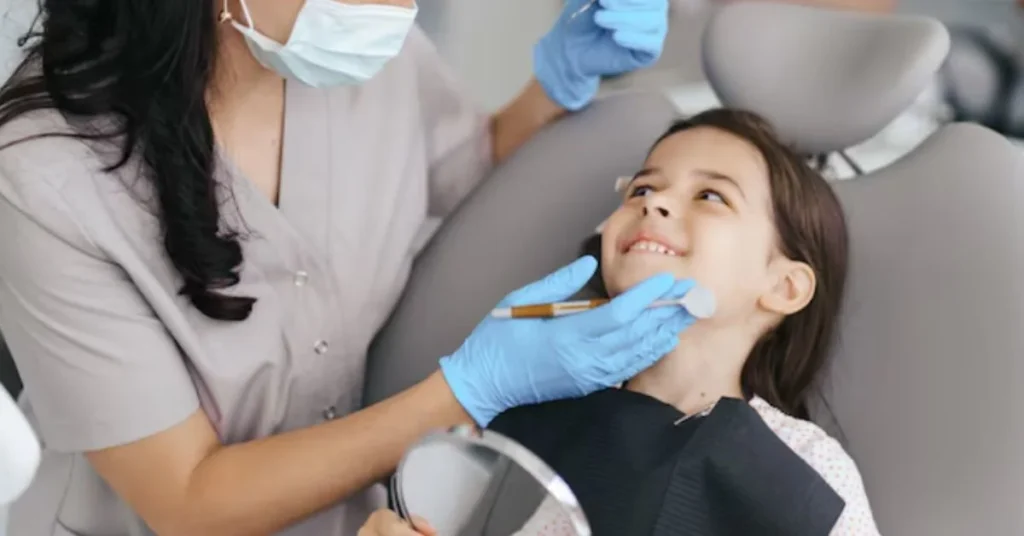 Smiling child receiving gentle dental checkup in modern clinic chair